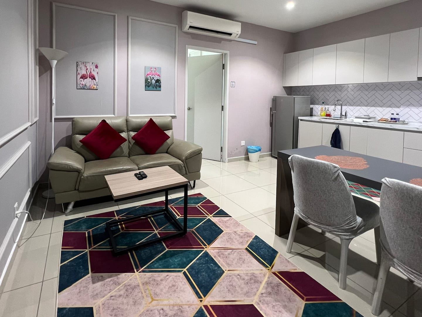 Living area of the Hyde Tower unit, with sofa, rug and dining table.